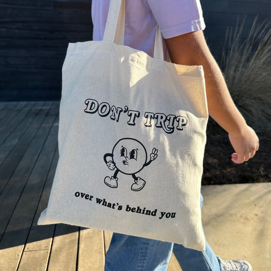Don't trip over what's behind you tote bag