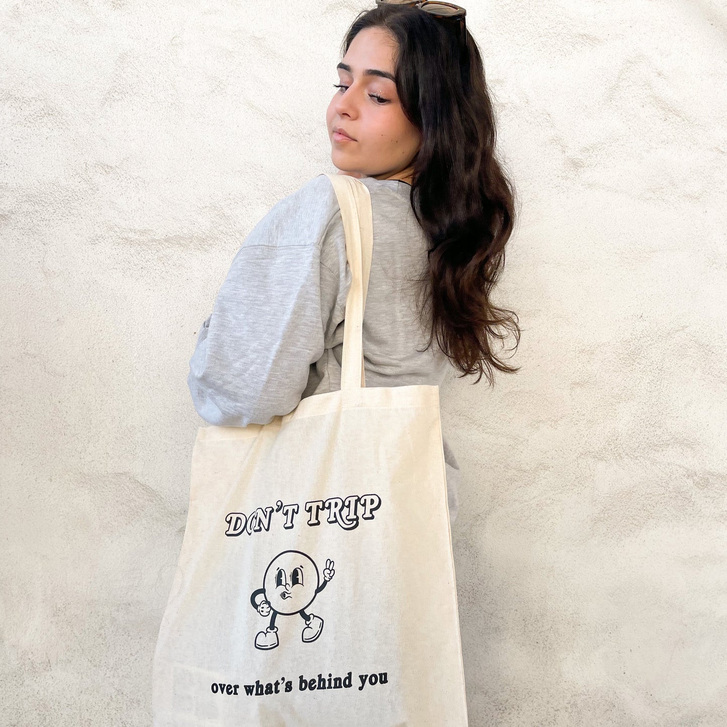 Don't trip over what's behind you tote bag