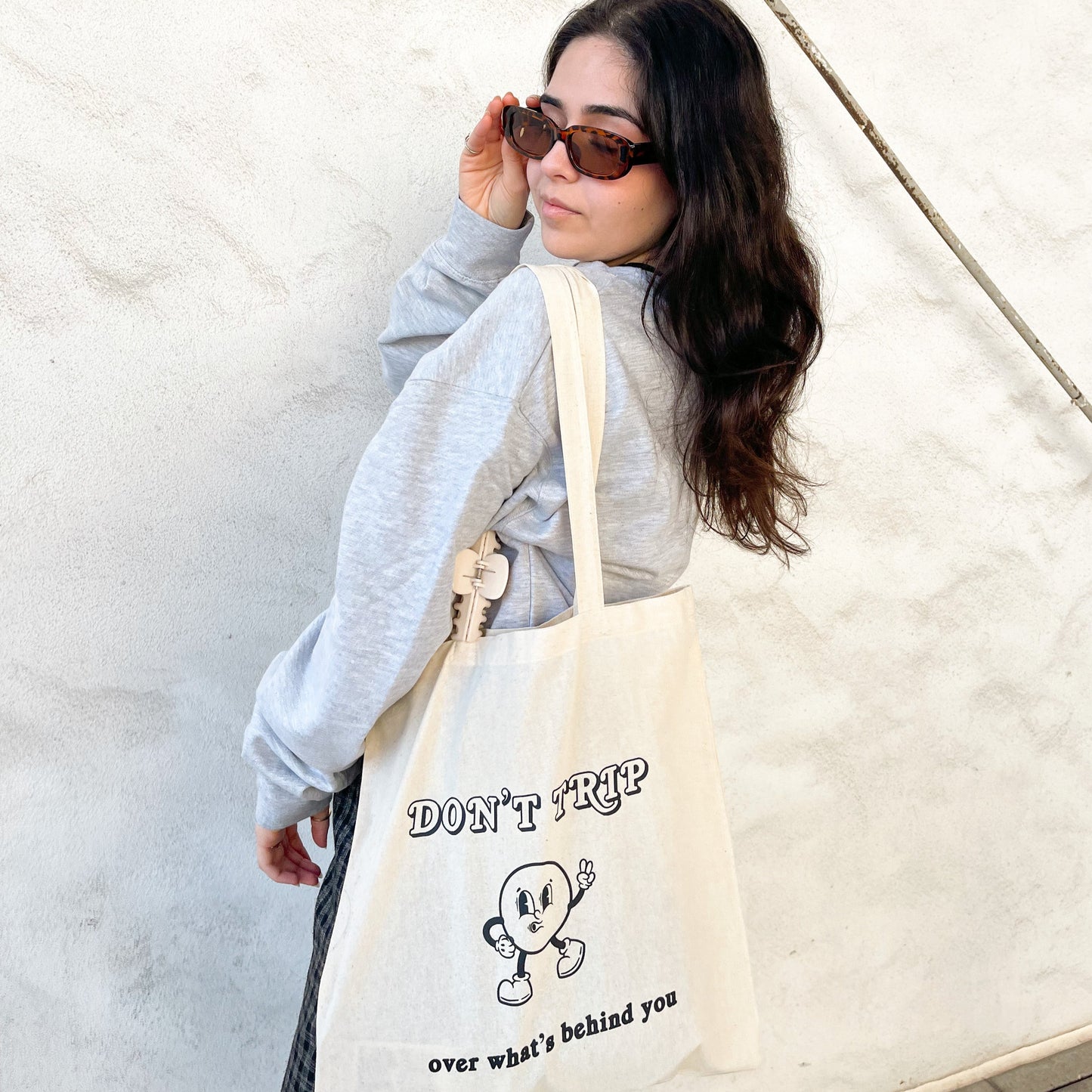 Don't trip over what's behind you tote bag